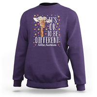 Purple autism awareness sweatshirt with giraffe floral graphic: 'It's OK to be different'