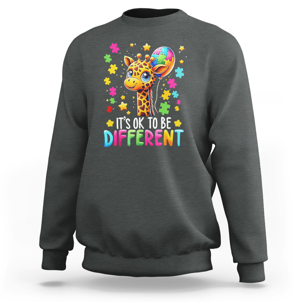 Charcoal gray crewneck sweatshirt with colorful giraffe puzzle graphic and “It’s ok to be different” text
