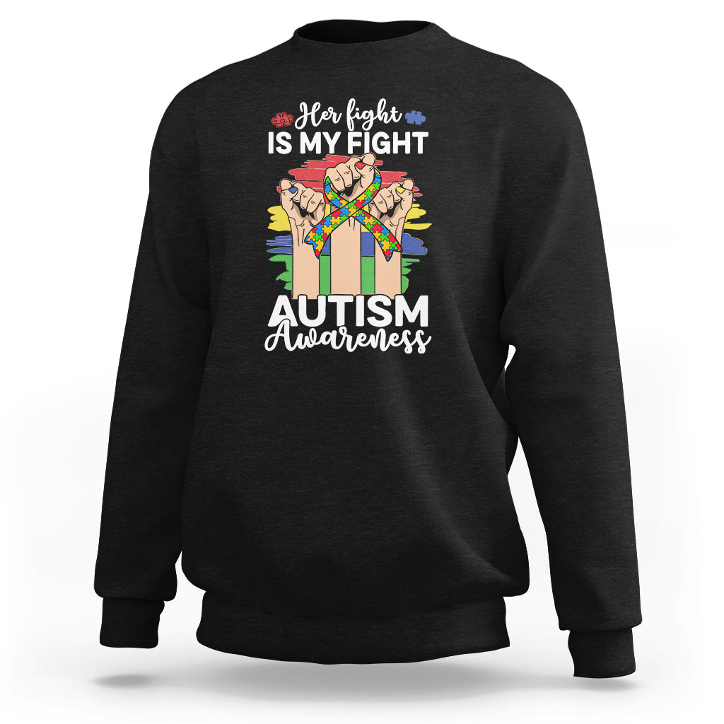 Autism support sweatshirt in black with rainbow ribbon, puzzle piece and raised fists graphic