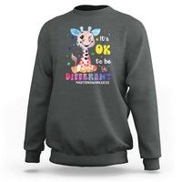 Charcoal autism giraffe sweatshirt with “It’s OK to be different” graphic