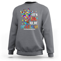 Charcoal crewneck sweatshirt with colorful giraffe autism awareness graphic on back.