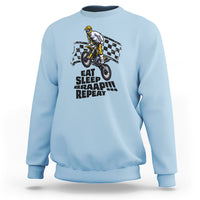 Light blue dirtbike sweatshirt with front rider graphic and “EAT SLEEP BRAAP REPEAT” text.