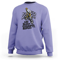 Violet dirtbike sweatshirt with front rider graphic and “EAT SLEEP BRAAP REPEAT” text.
