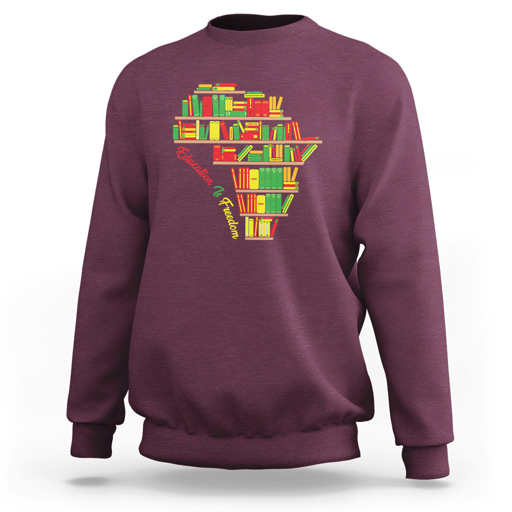 Maroon crewneck sweatshirt with colorful books heart graphic at the chest