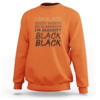 Orange crewneck sweatshirt with front graphic text print and ribbed cuffs and hem.