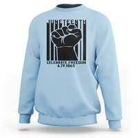 Light blue crewneck sweatshirt with black Juneteenth-style fist graphic on the front