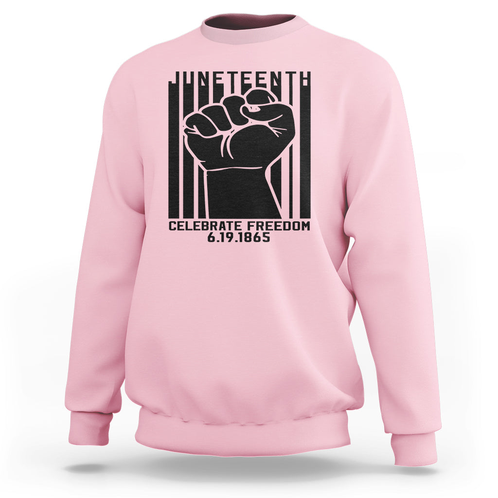 Light pink crewneck sweatshirt with black Juneteenth-style fist graphic on the front
