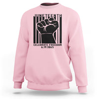Light pink crewneck sweatshirt with black Juneteenth-style fist graphic on the front