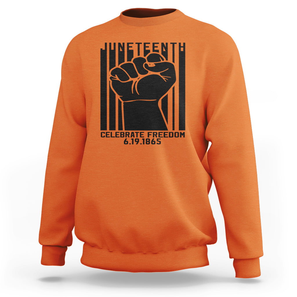 Orange crewneck sweatshirt with black Juneteenth-style fist graphic on the front