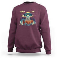 Maroon crewneck sweatshirt with colorful UFO and pine forest graphic
