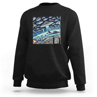 Graphic UFO sweatshirt with front rectangular "World UFO Day" print on black fabric.