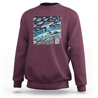 Graphic UFO sweatshirt with front rectangular "World UFO Day" print, maroon.