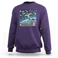 Graphic UFO sweatshirt with front rectangular "World UFO Day" print, purple.