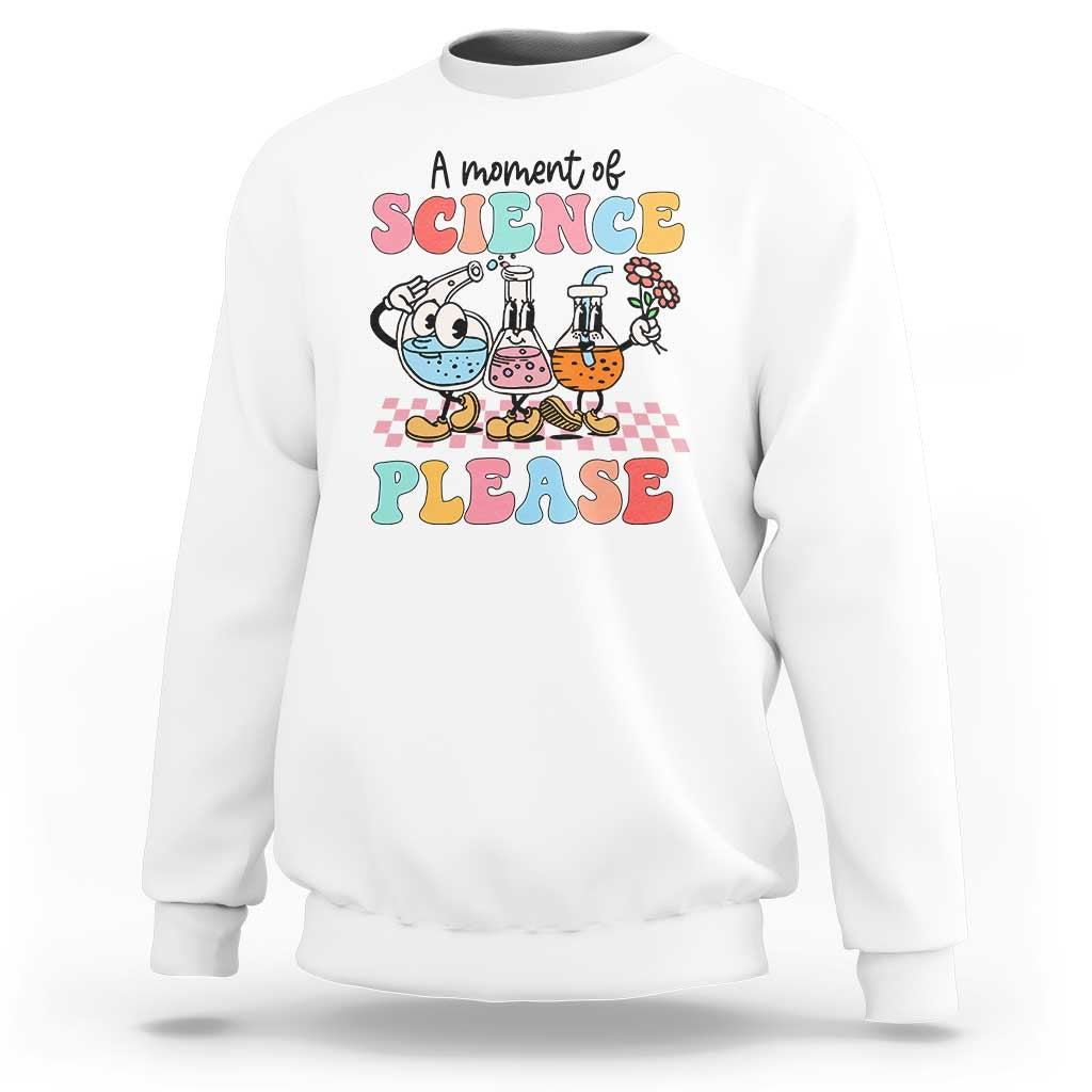 White sweatshirt with science beakers graphic and 'A moment of Science Please'