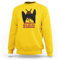 Yellow sweatshirt with black mothman graphic and red text "MOTHMAN IS REAL"