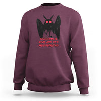 Maroon sweatshirt with black mothman graphic and red text "MOTHMAN IS REAL"