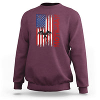 Maroon crewneck sweatshirt with American flag-style graphic and vertical red text on chest