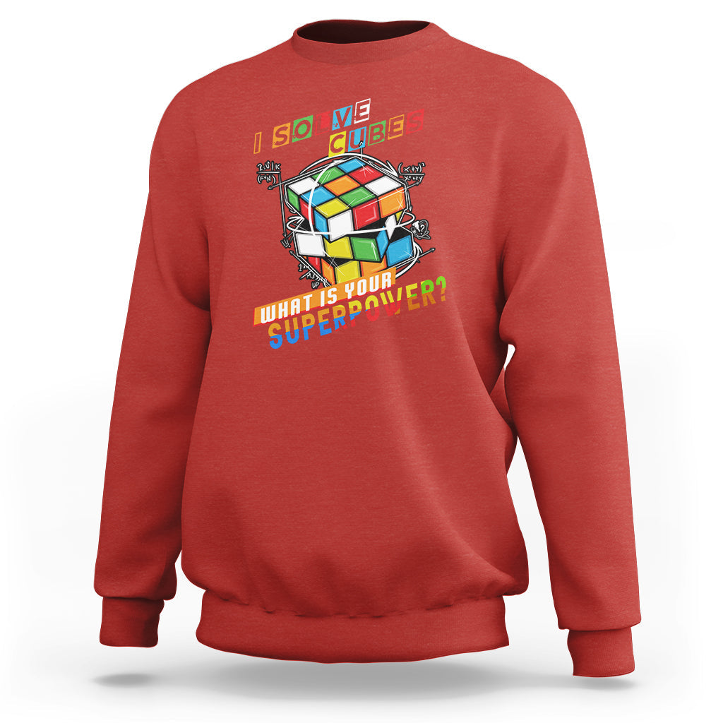 Red crewneck sweatshirt with colorful cube graphic and 'What is your superpower?' text