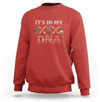 Red crewneck sweatshirt with “IT’S IN MY DNA” graphic and tribal fish design