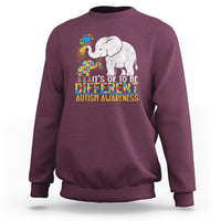 Maroon crewneck sweatshirt with colorful elephant autism awareness graphic and slogan