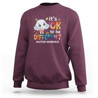 Maroon sweatshirt with cartoon elephant graphic and “It’s OK to be DIFFERENT” text