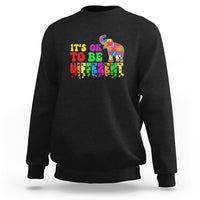 Black sweatshirt with colorful elephant and “It’s ok to be different” lettering graphic