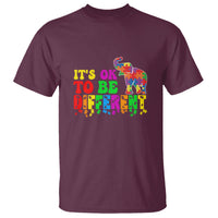 Maroon graphic T-shirt with colorful elephant and "It's OK to be different" text