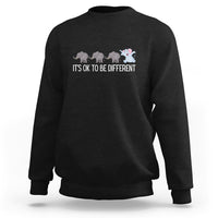 Black crewneck sweatshirt with elephant graphic and “It’s OK to be different” text