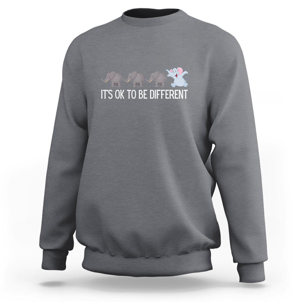 Gray crewneck sweatshirt with elephant graphic and “It’s OK to be different” text