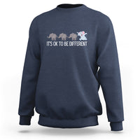 Navy crewneck sweatshirt with elephant graphic and “It’s OK to be different” text
