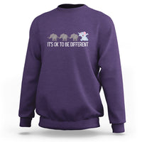 Purple crewneck sweatshirt with elephant graphic and “It’s OK to be different” text