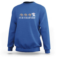 Royal blue crewneck sweatshirt with elephant graphic and “It’s OK to be different” text
