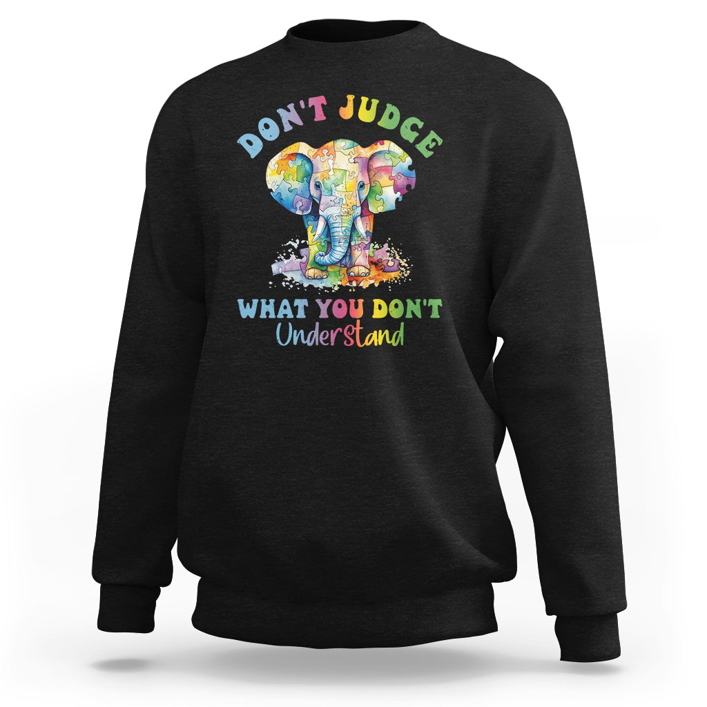 Black sweatshirt with colorful elephant graphic and slogan 'DON'T JUDGE' on back.