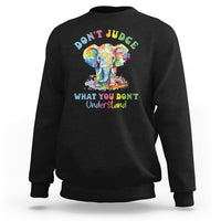 Black sweatshirt with colorful elephant graphic and slogan 'DON'T JUDGE' on back.