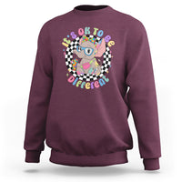 Maroon crewneck sweatshirt with colorful elephant “It’s Okay To Be Different” graphic
