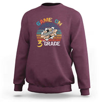 Maroon sweatshirt with “GAME ON” and “3RD GRADE” gamer graphic on chest
