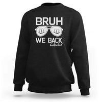 Black crewneck sweatshirt with “BRUH WE BACK” graphic and books-in-glasses print