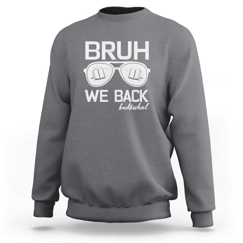 Charcoal crewneck sweatshirt with “BRUH WE BACK” graphic and books-in-glasses print