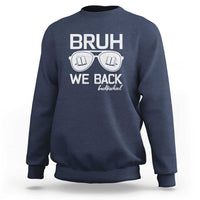 Navy crewneck sweatshirt with “BRUH WE BACK” graphic and books-in-glasses print