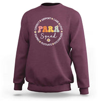 Maroon crewneck sweatshirt with colorful “PARA Squad” circular graphic on chest