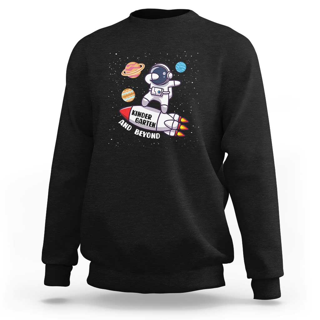 Black sweatshirt with astronaut graphic and “Kinder Garten and Beyond” text