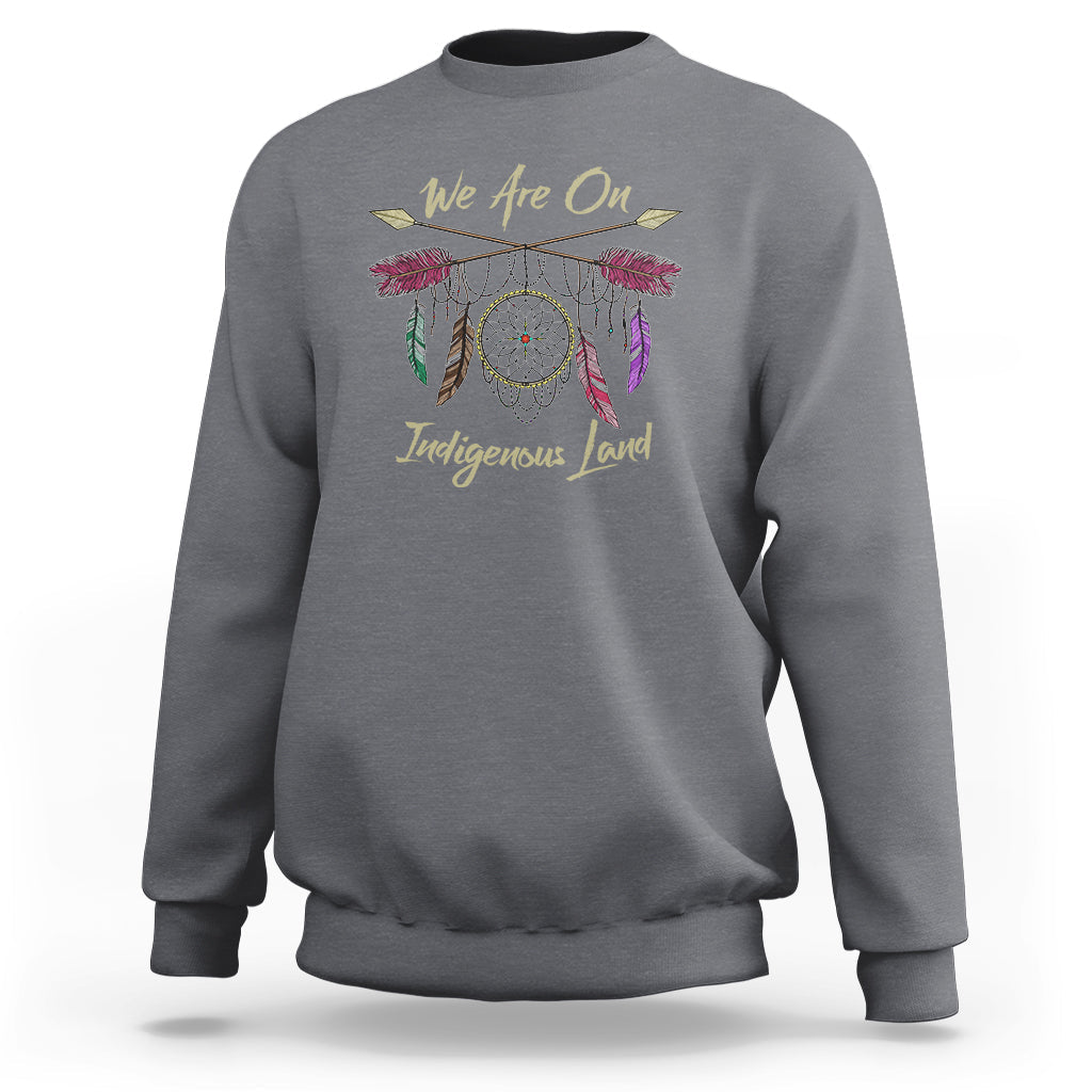 Charcoal gray sweatshirt with dreamcatcher and 'We Are On Indigenous Land' front print