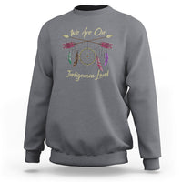 Charcoal gray sweatshirt with dreamcatcher and 'We Are On Indigenous Land' front print