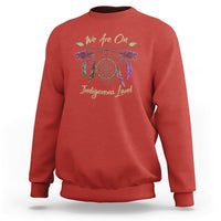 Red sweatshirt with dreamcatcher and 'We Are On Indigenous Land' front print