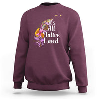 Maroon Native American sweatshirt with 'It's All Native Land' feather graphic
