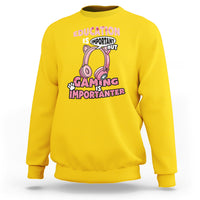 Daisy yellow crewneck sweatshirt with pink gaming-themed graphic text, front view