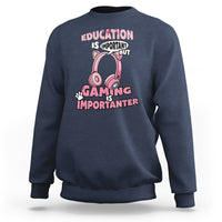 Navy blue crewneck sweatshirt with pink gaming-themed graphic text, front view