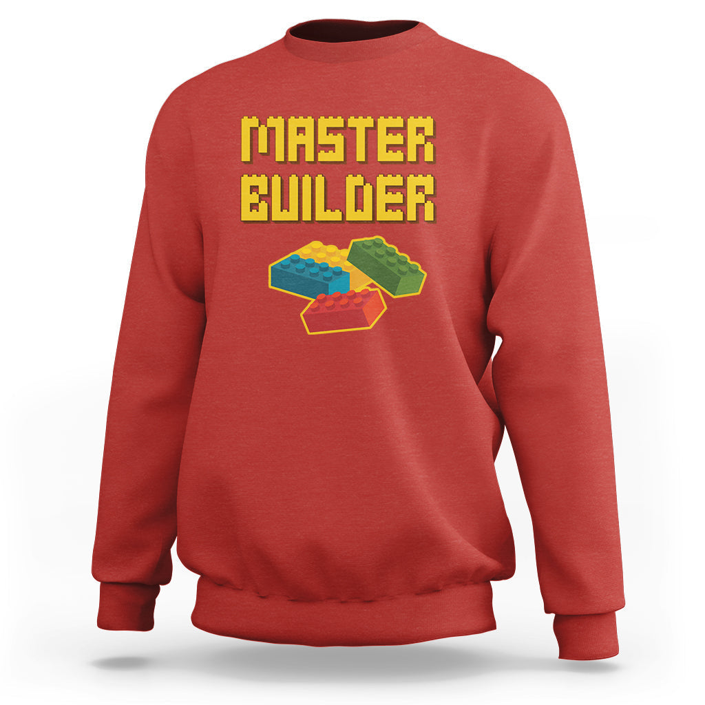 Red sweatshirt with “Master Builder” text and colorful block builder graphic