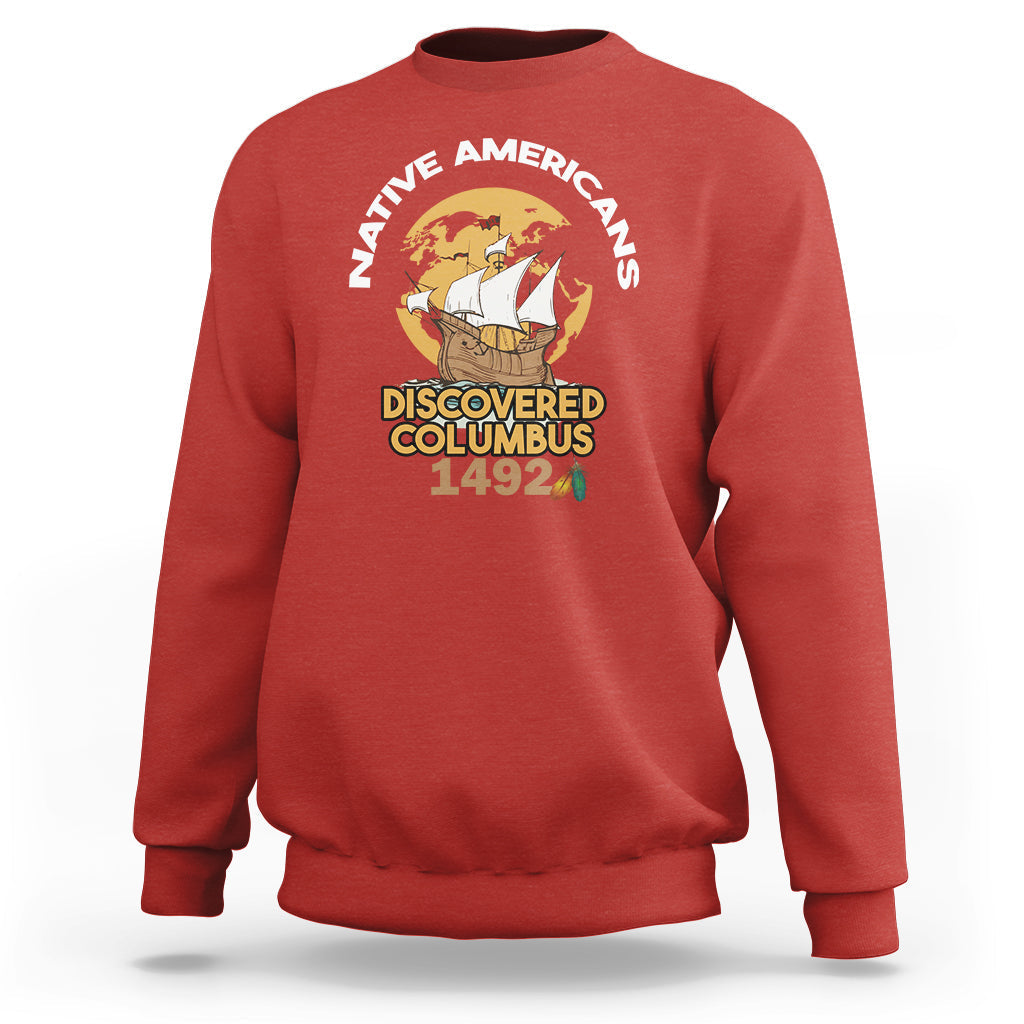 Red crewneck sweatshirt with “Discovered Columbus 1492” graphic on chest