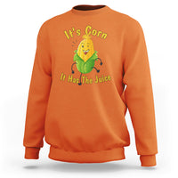 Orange sweatshirt with “It’s Corn” corn character graphic and yellow slogan text